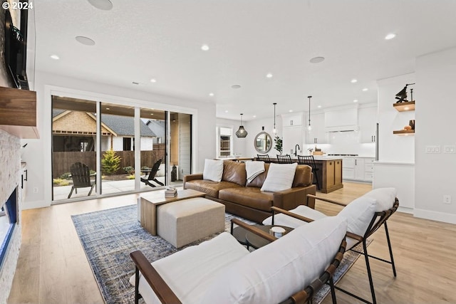 living room with sink and light hardwood / wood-style floors