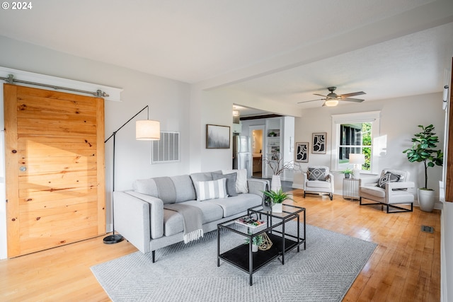 living room featuring ceiling fan and hardwood / wood-style floors