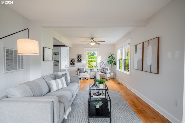 living room featuring hardwood / wood-style flooring and ceiling fan