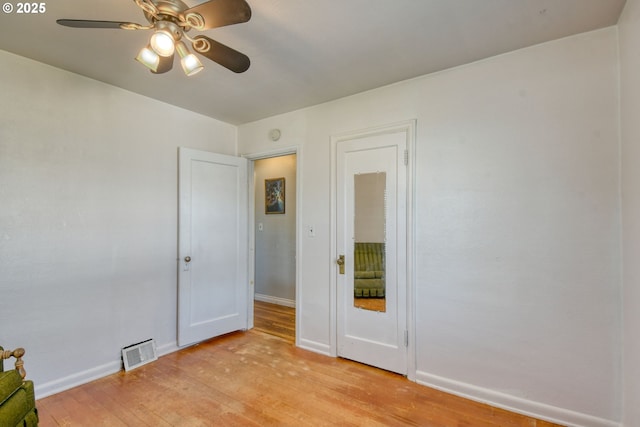 unfurnished bedroom with baseboards, a ceiling fan, light wood-type flooring, and visible vents