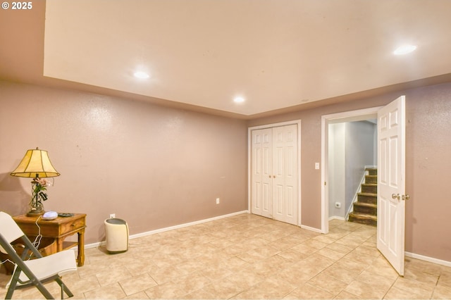 interior space featuring recessed lighting, baseboards, stairs, and light tile patterned floors