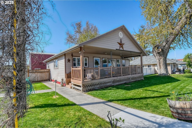 bungalow with fence and a front yard