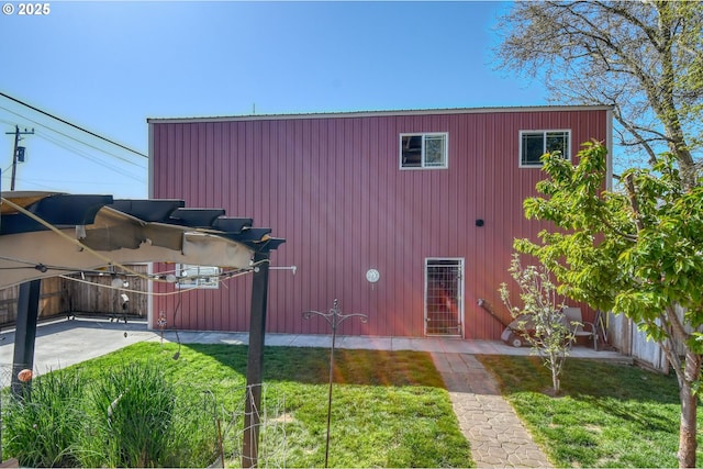 exterior space with fence and a front lawn