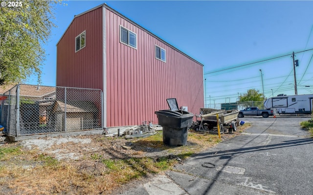 view of outdoor structure with fence and an outbuilding