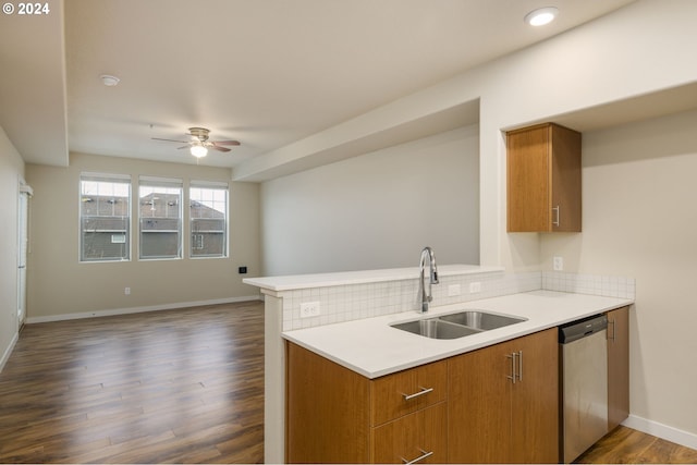 kitchen with a sink, brown cabinets, dishwasher, and dark wood-style floors