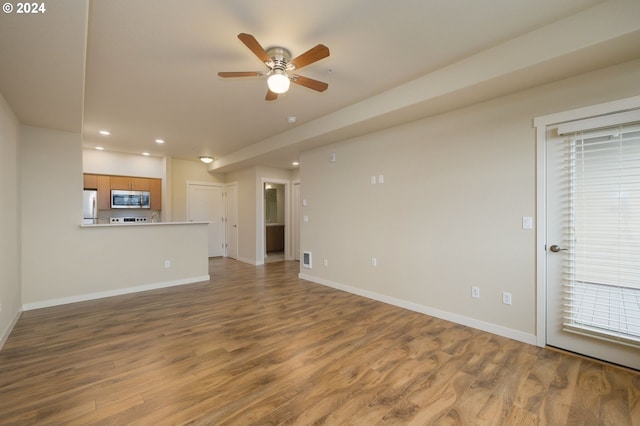 unfurnished living room with recessed lighting, a ceiling fan, baseboards, and wood finished floors