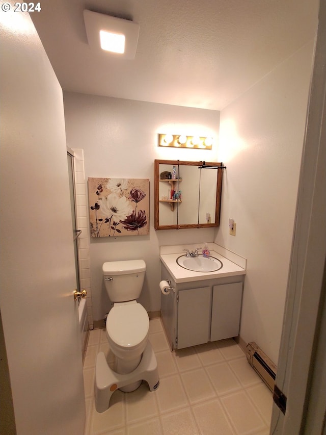 bathroom with vanity, a baseboard heating unit, a shower with shower door, and toilet