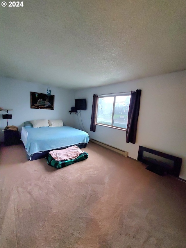 bedroom featuring a baseboard radiator, a textured ceiling, and carpet flooring