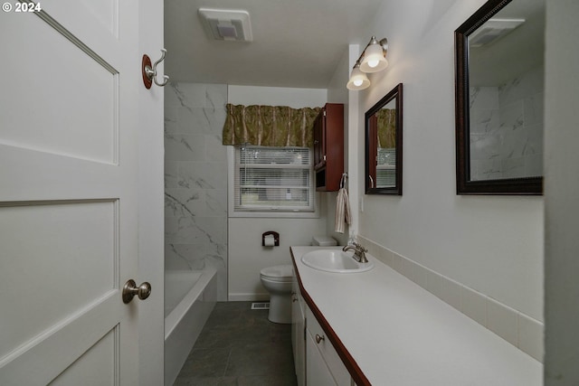 full bathroom featuring toilet, vanity, and tiled shower / bath