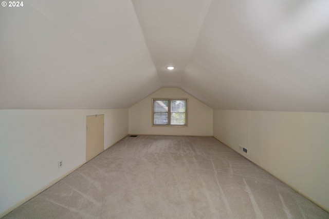 bonus room featuring light colored carpet and lofted ceiling