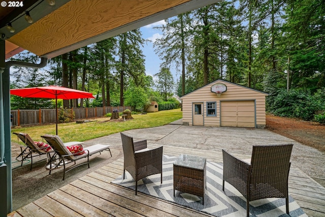 wooden terrace with a garage, a storage shed, and a lawn