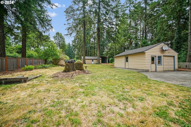 view of yard with a garage and a storage unit