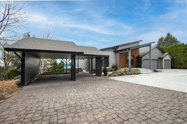 view of front facade with a garage and a carport