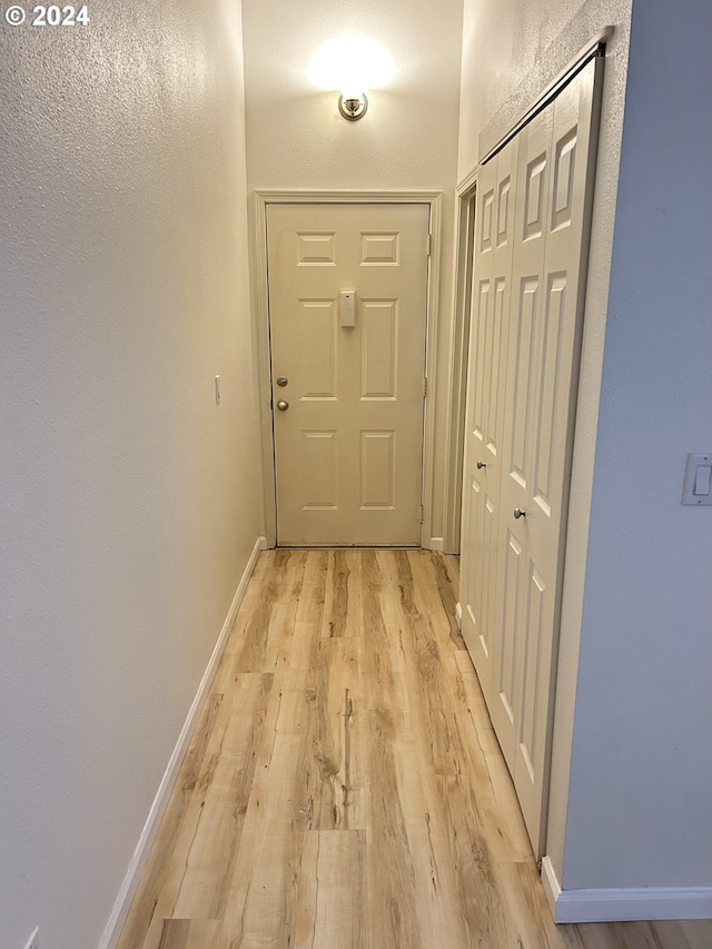 corridor with light hardwood / wood-style flooring