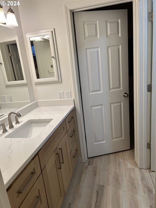 bathroom featuring vanity and hardwood / wood-style flooring