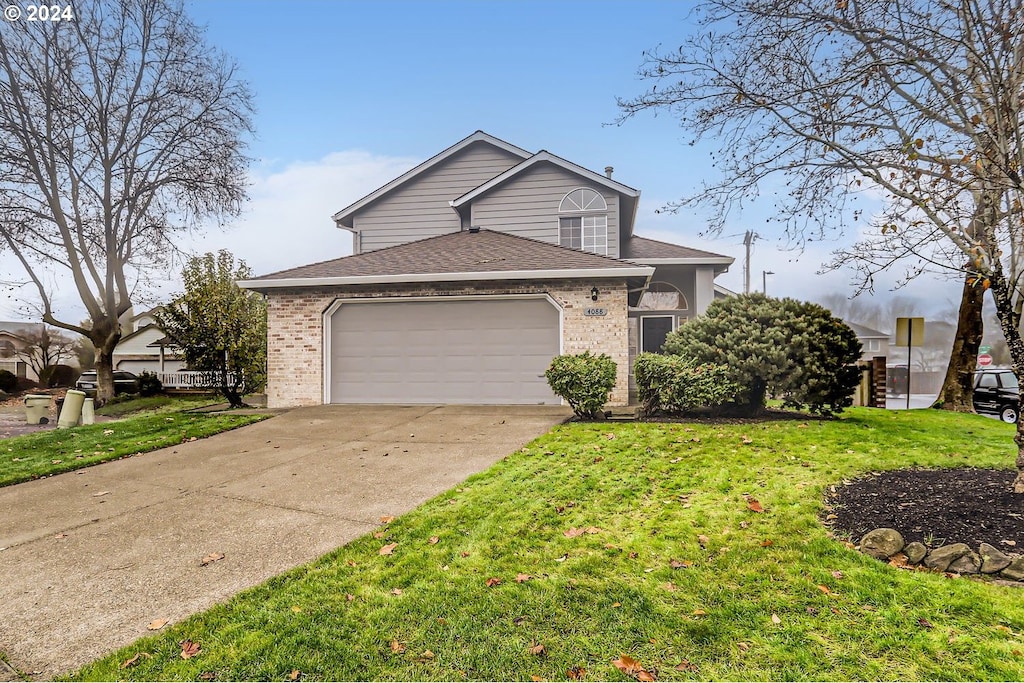 view of front of house with a front yard and a garage