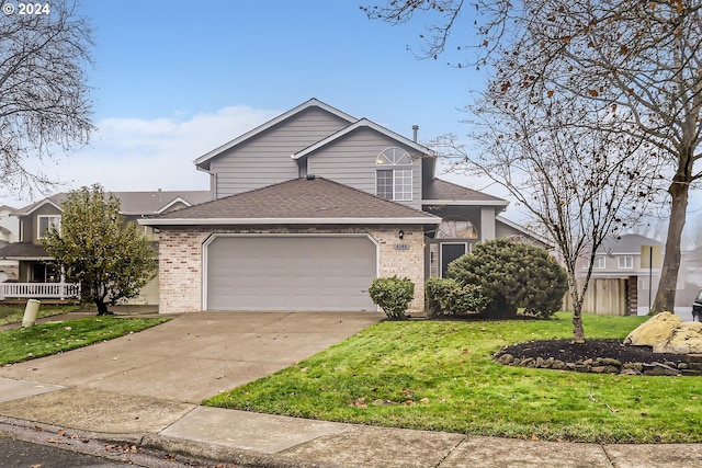 view of front of house featuring a garage and a front lawn