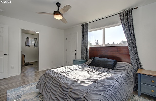 bedroom with ceiling fan and dark hardwood / wood-style flooring