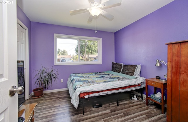 bedroom with ceiling fan and dark hardwood / wood-style floors