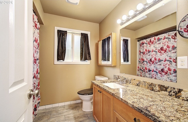 bathroom featuring toilet and vanity