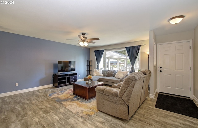 living room with hardwood / wood-style flooring and ceiling fan