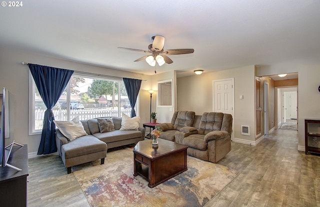 living room with ceiling fan and hardwood / wood-style floors