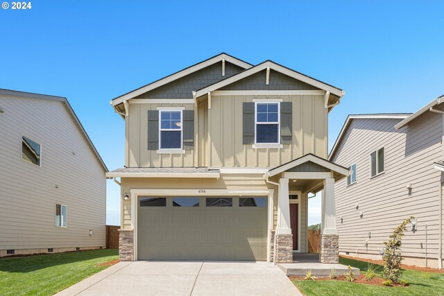 craftsman-style house with a garage and a front lawn