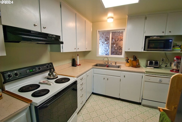 kitchen featuring white cabinetry, sink, and white appliances