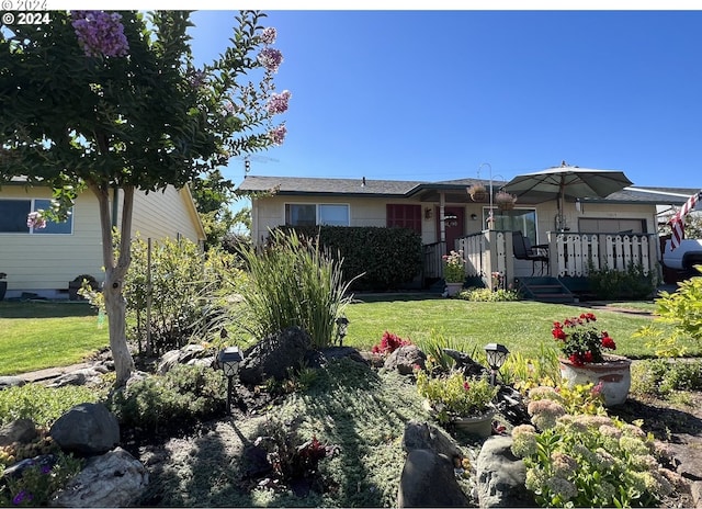 view of front of home with a garage and a front yard