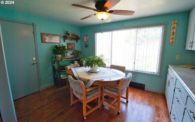 dining area with a textured ceiling, a wealth of natural light, dark wood-type flooring, and ceiling fan