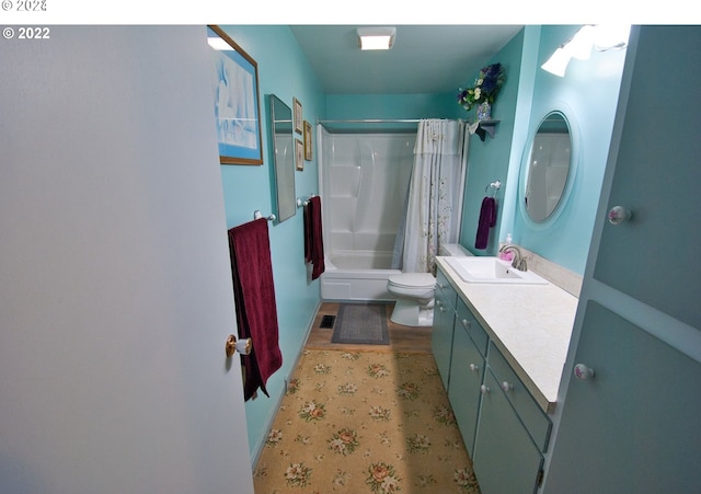 full bathroom featuring vanity, shower / bath combination with curtain, and toilet