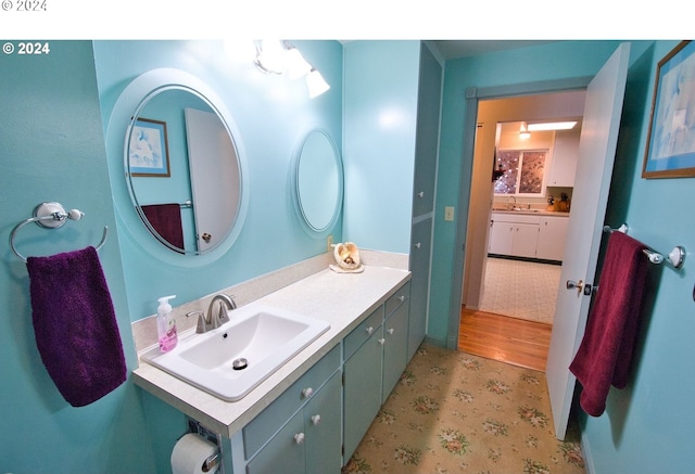 bathroom with vanity and hardwood / wood-style flooring