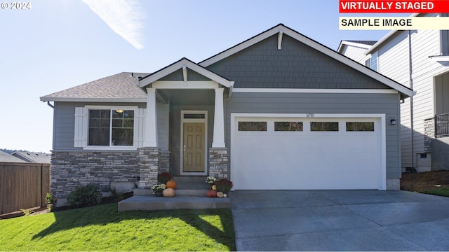 craftsman-style house with a garage, a front yard, concrete driveway, and fence