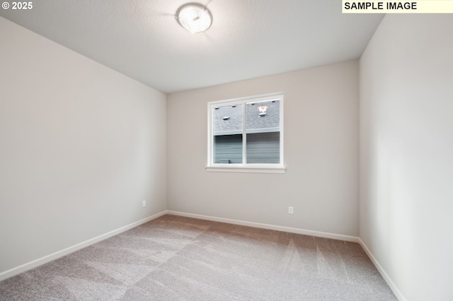 empty room featuring carpet floors and baseboards