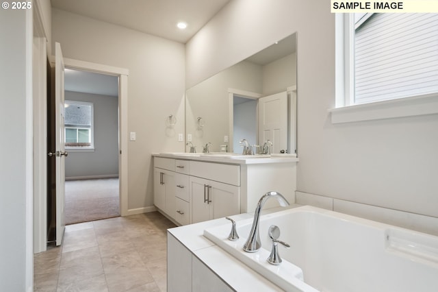 full bath with tile patterned flooring, baseboards, a bath, and vanity