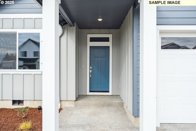 property entrance featuring a garage, crawl space, and board and batten siding