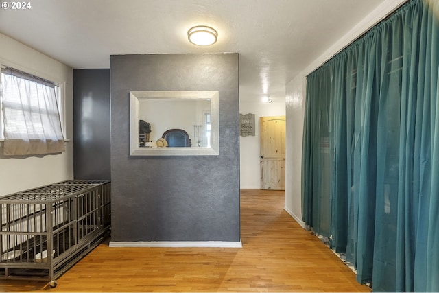 hall with wood finished floors and baseboards