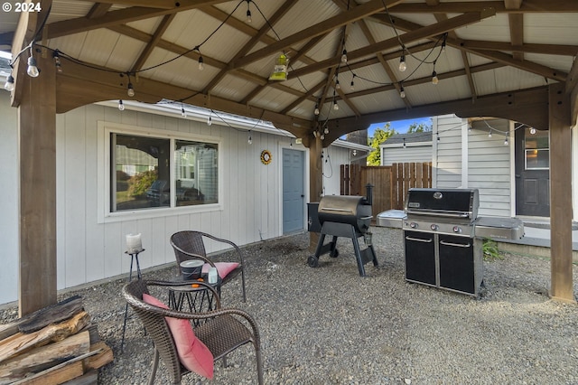 view of patio featuring fence, grilling area, and a gazebo