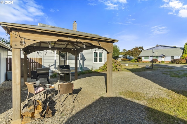 view of patio / terrace with a gazebo, grilling area, and fence