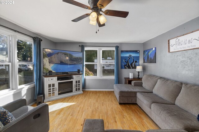 living room featuring light hardwood / wood-style flooring and ceiling fan