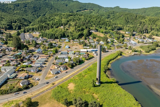 drone / aerial view featuring a water and mountain view