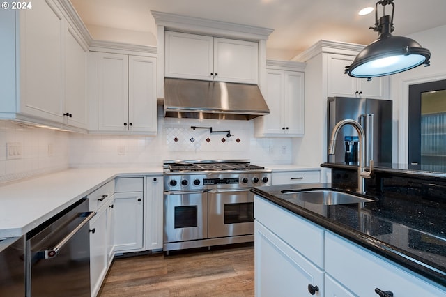 kitchen featuring stainless steel appliances, wood-type flooring, and white cabinets