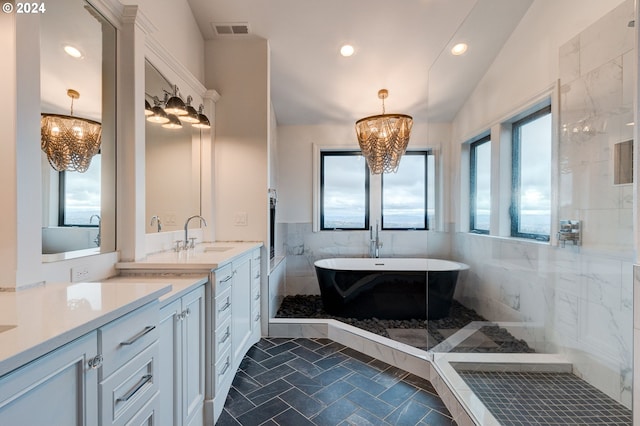 bathroom with tile walls, a tub, a healthy amount of sunlight, and lofted ceiling