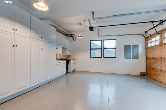 garage with electric panel, baseboards, and a garage door opener