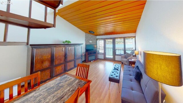 living room featuring wooden ceiling, vaulted ceiling, and light hardwood / wood-style flooring