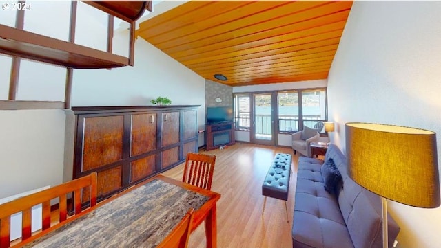 interior space featuring lofted ceiling, wooden ceiling, and french doors