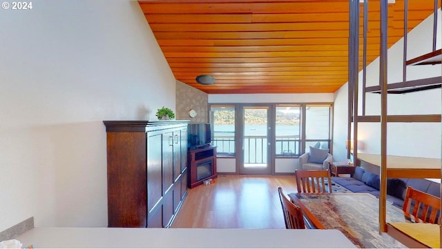 sunroom featuring lofted ceiling and wooden ceiling