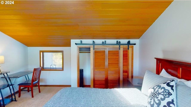 carpeted bedroom featuring lofted ceiling, a barn door, wood ceiling, and baseboards