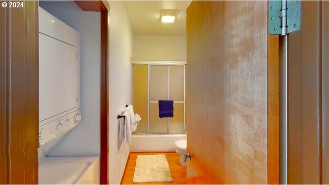 hallway with light wood-type flooring and a textured ceiling