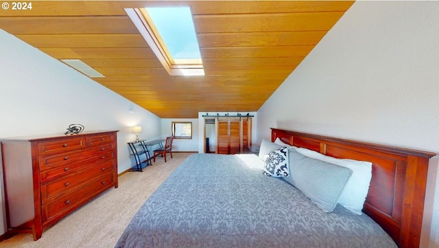 bedroom with vaulted ceiling with skylight, wood ceiling, and light colored carpet